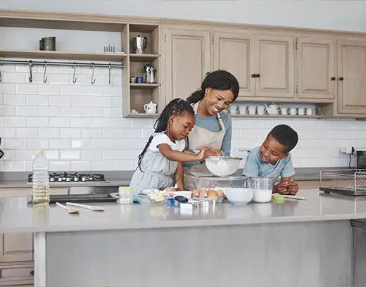 mother baking with her children at home in newly renovated kitchen